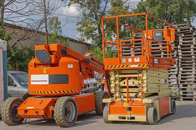 forklift moving heavy loads in busy warehouse setting in Centereach